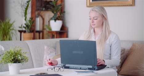 businesswoman working on laptop on a project at home office young woman using laptop computer 2