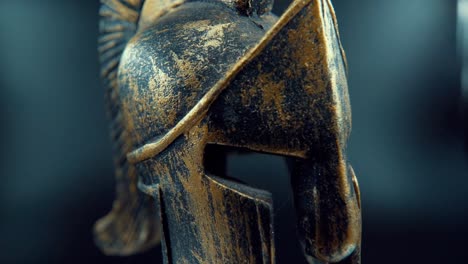 a close up macro cinematic detailed shot of a spartan design, warrior metal bronze helmet, on a 360 rotating stand, studio lighting, full hd video, super slow motion 120 fps