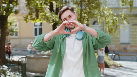 man making a heart shape with his hands