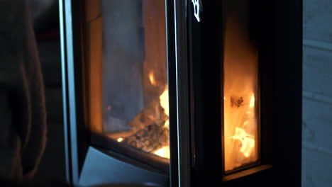 close slomo tilt down of fire in modern wood burning stove indoors