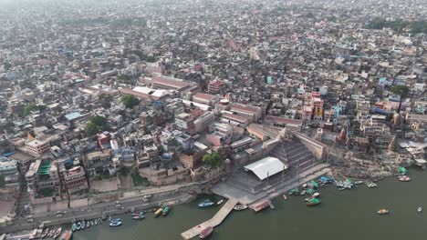 overhead view of a sprawling varanasi neighborhood, with the ganges serving as the lifeline of this densely packed city.