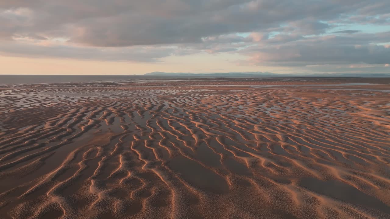 Tidal Sands With Ripples And Pools Of Seawater At Sunset. Camera Slow Flight Over. Fleetwood, Lancashire, UK