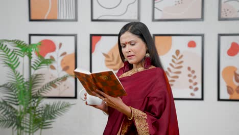 indian woman reading book with coffee