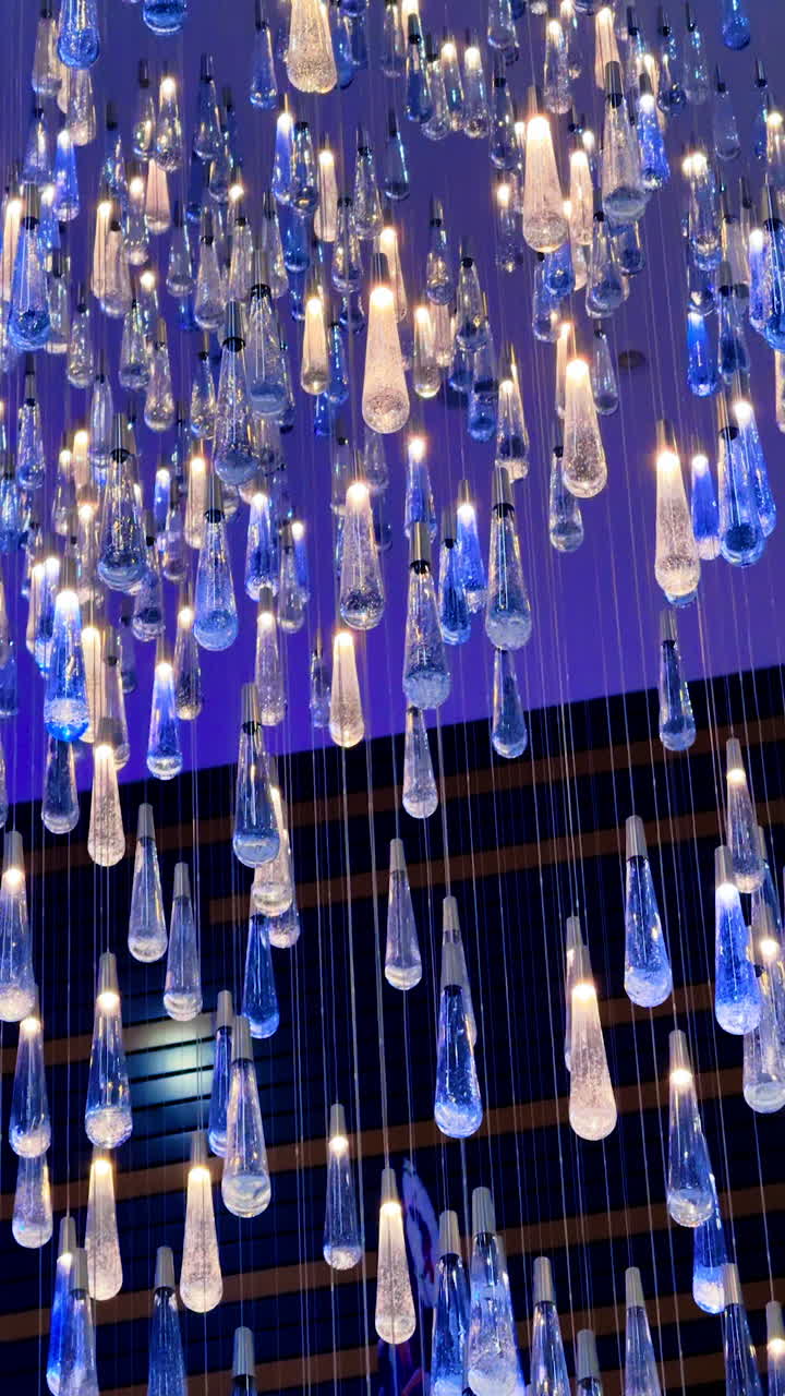 Elegant lighting arrangement at an event. A stunning display of hanging lights creates an inviting atmosphere in a modern venue during evening festivities