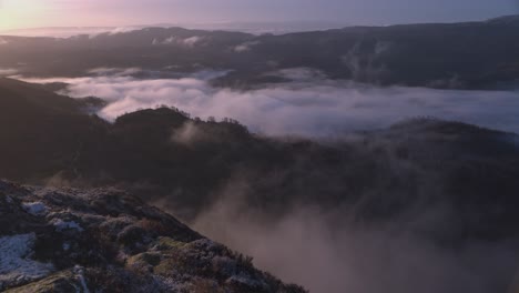 Static-shot-of-low-lying-clouds-travelling-through-the-valley-below-Ben-A'an