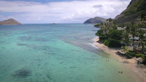 on this stone-sand tropical beach in hawaii, the turquoise sea provides a stunning visual spectacle