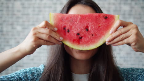 woman enjoying a watermelon slice