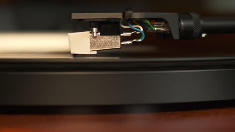 close up view of a turntable needle with platter spinning, slow motion 4k