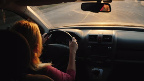 silhouette of a female driver driving a car