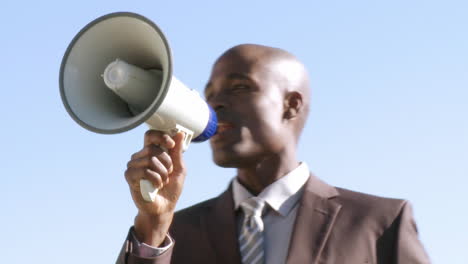 africanamerican businessman screaming instruction though a megaphone