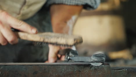 a blacksmith with a metal brush cleans the workpiece from scale and debris artisan craftsmanship