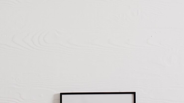 Black frame with copy space on white background and white wall