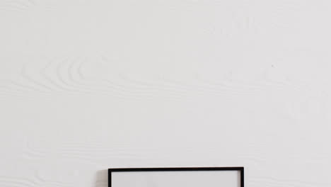 black frame with copy space on white background and white wall