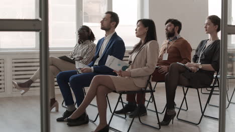 multiethnic colleagues sitting in conference room