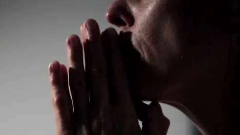 woman praying to god with hands together on grey background stock footage