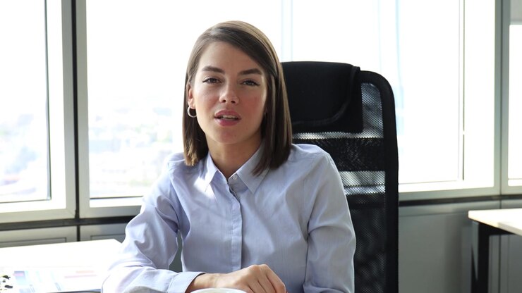 Young Businesswoman Talking and Smiling in Modern Office