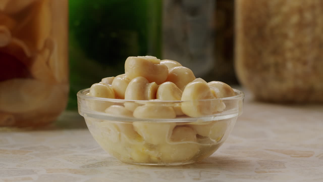 Fermented champignons, Jar with marinated mushrooms on wooden table, traditional salted marinated asian food.