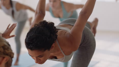 Hermosa-Mujer-De-Yoga-Practicando-Pose-De-Guerrero-En-El-Gimnasio-Entrenamiento-Femenino-Hispano-Con-Instructor-Grupo-De-Mujeres-Disfrutando-De-Un-Estilo-De-Vida-Saludable-Y-Equilibrado