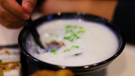 savoring a bowl of delicious pork porridge