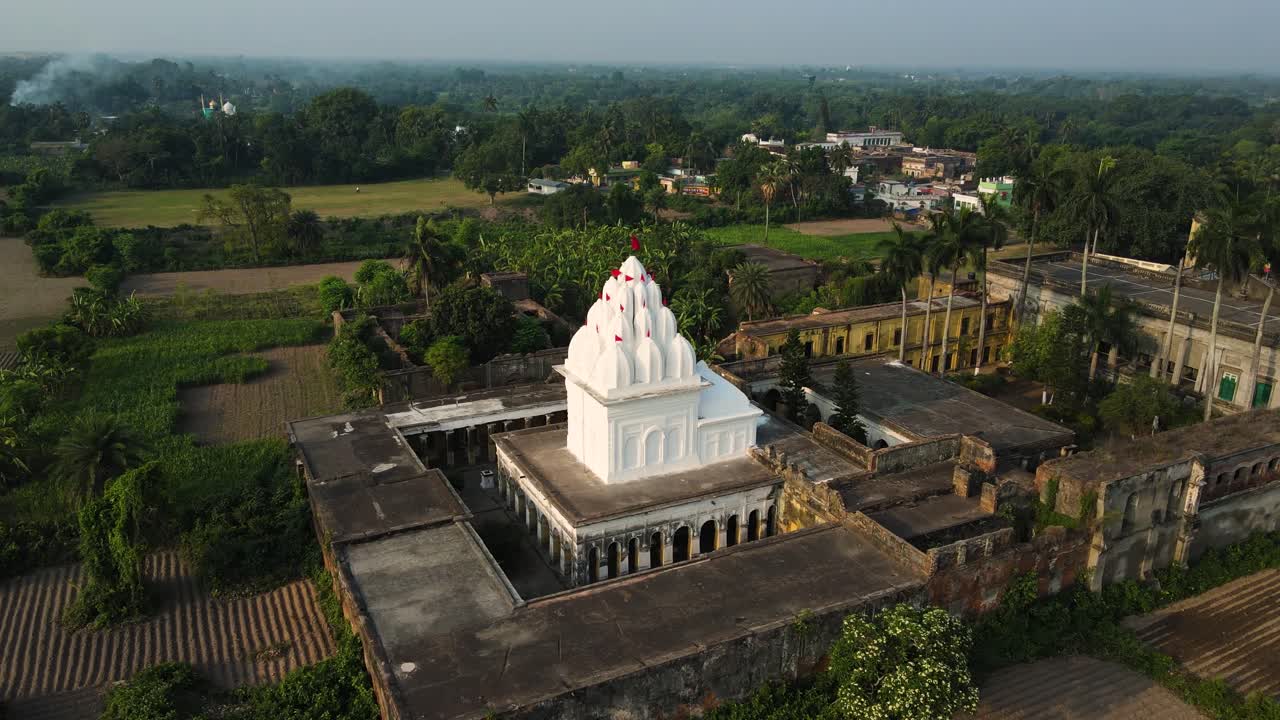 Stunning aerial view of a white-colored temple, highlighting its intricate design and serene surroundings.