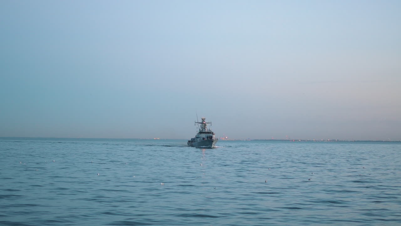 해질녘에 바다를 항해하는 군함