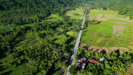 asphalt road on the rural town of timbaan in the municipality of san andres, province of catanduanes, philippines. aerial shot