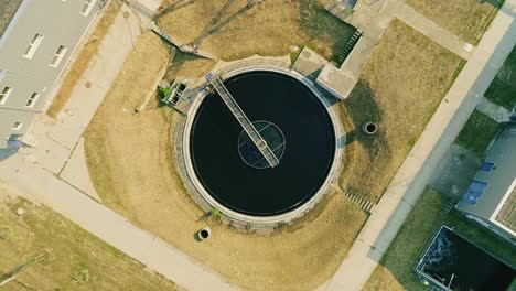 Engineer-comes-to-check-the-sewage-treatment-plant---aerial-shot