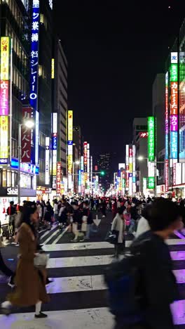 nighttime scene of a busy city street in shinjuku, japan