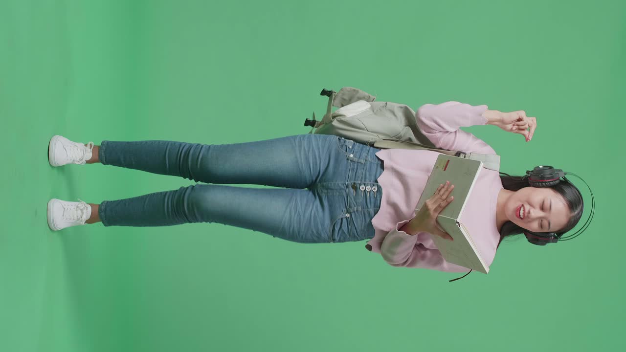 estudiante escuchando música, sosteniendo libros, pantalla verde