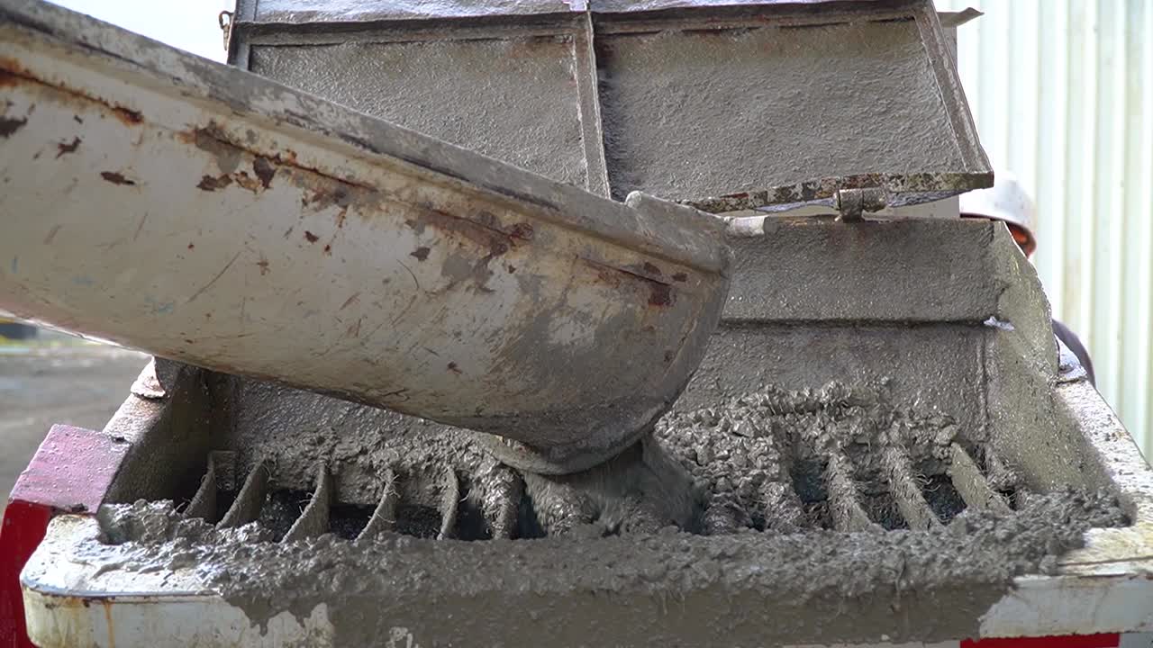 Cement Mix Slowly Falling From A Conveyor Into A Container At A