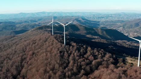 Spinning-blades-of-wind-turbines-on-top-of-mountain,-Savona,-Italy