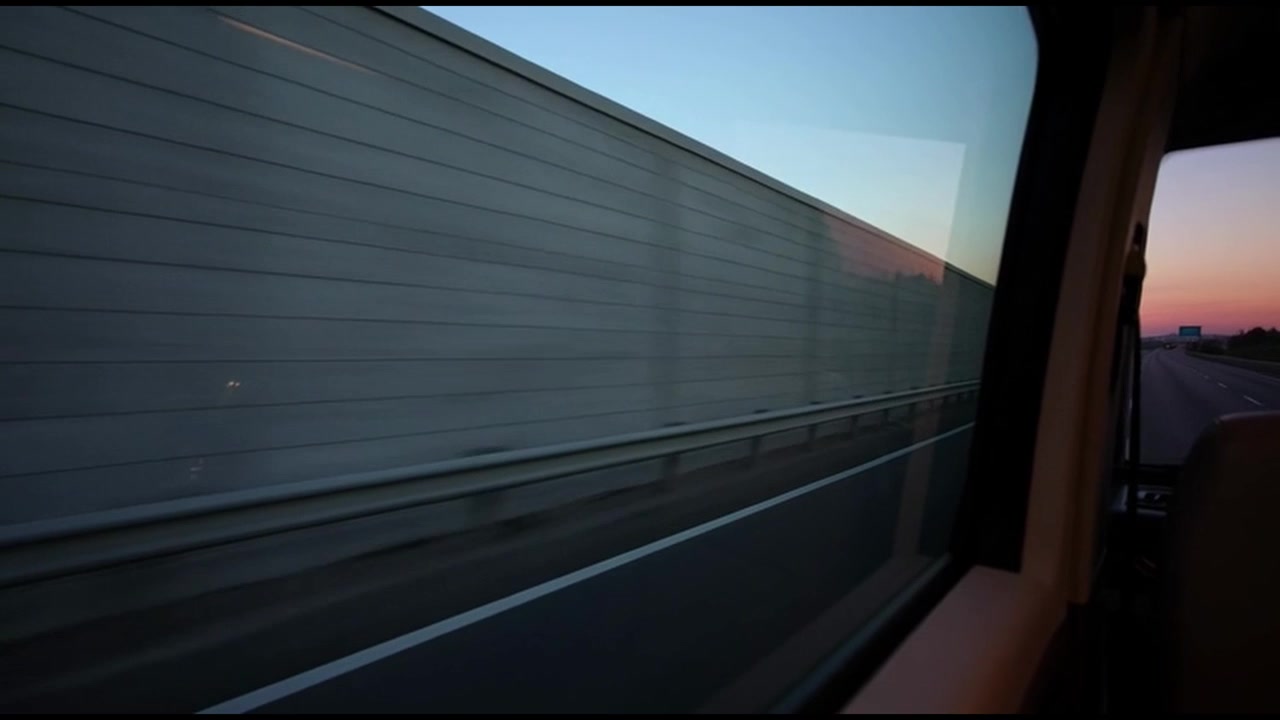 View From Car Window Driving Along Highway at Sunset