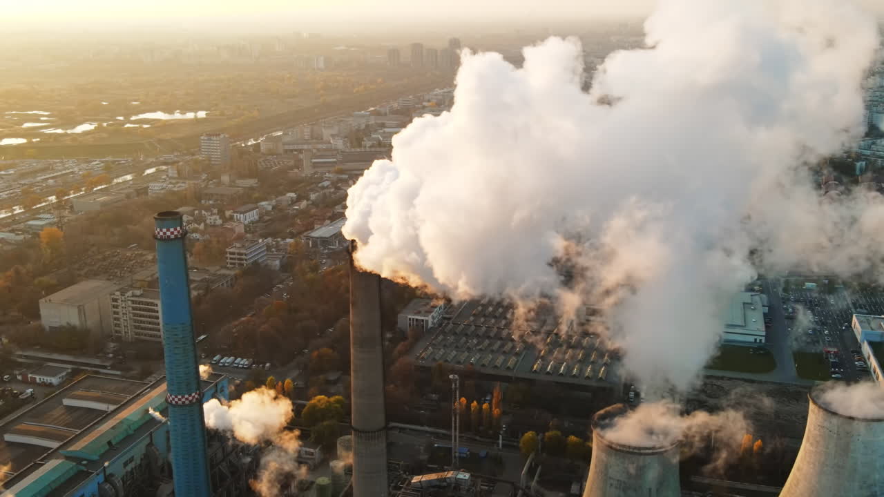 Power station with a lot of tubes and facilities in Bucharest at sunset, a lot of foam. Cityscape, view from the drone, Romania