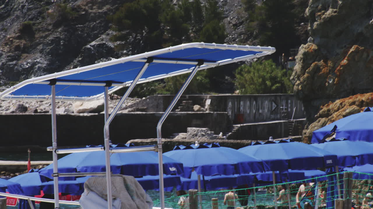 Giant Colossal Statue Of Neptune At Fegina Beach With Boats Docked In Monterosso al Mare, Italy. tilt-down reveal
