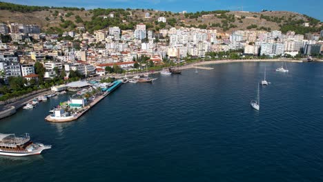 splendid blue bay of coastal saranda: boats, promenade, and the serene beauty of a calm city holiday