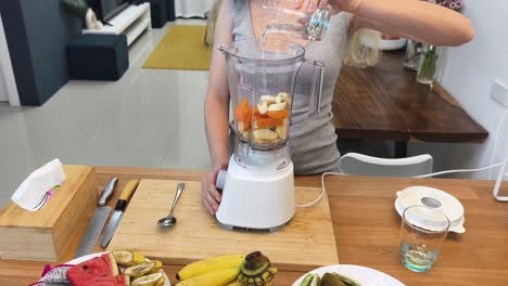 woman preparing a smoothie