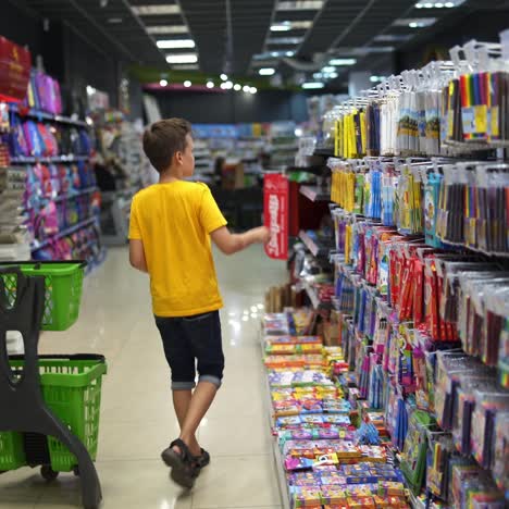 boy choosing school supplies
