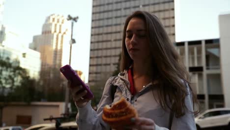 woman using smartphone on city street