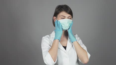 female surgeon in green gloves getting ready for operation, putting mask on. healthcare concept. shot in 4k.