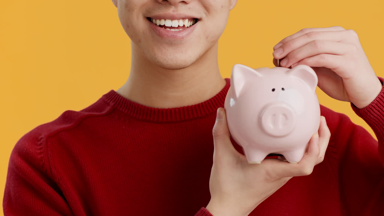 Person Saving Money in Piggy Bank