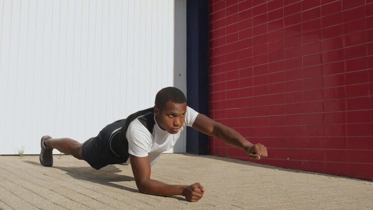 Young Black Man Stretching Before Running Outdoors