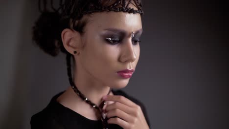 young beautiful girl posing in front of the camera her hair is in the form of a braid frame