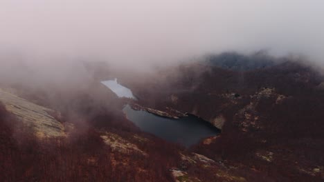 misty aerial view of a serene mountain lake in the dolomites mountains region