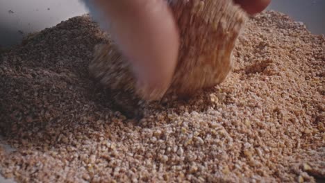 Chicken-nuggets-being-breaded-by-hand