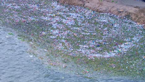 Aerial-top-down-of-garbage-and-plastic-from-ocean-washed-up-to-beach-in-Dominican-Republic