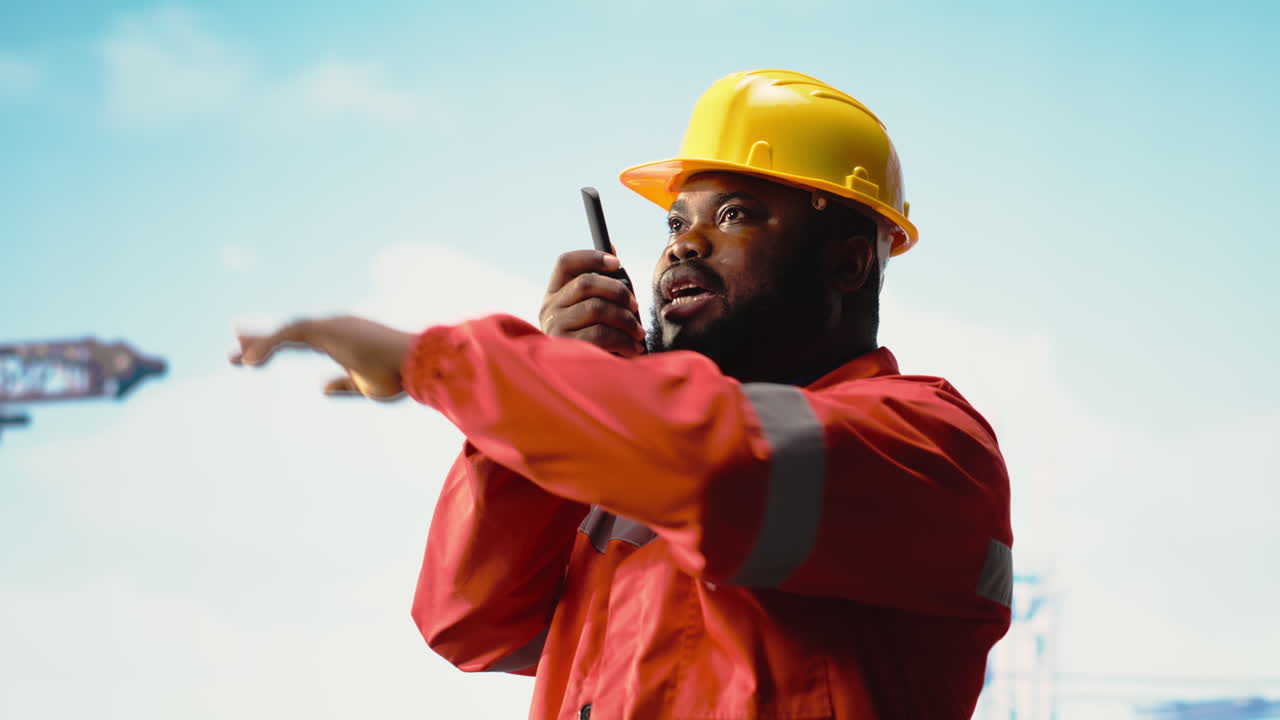 Vertical video Expert inspects integrity of offshore platform infrastructure, speaking in walkie talkie