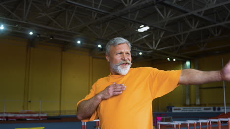 senior man stretching indoors