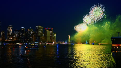 night celebration in beautiful new york, usa. fireworks splash in the sky over the east river