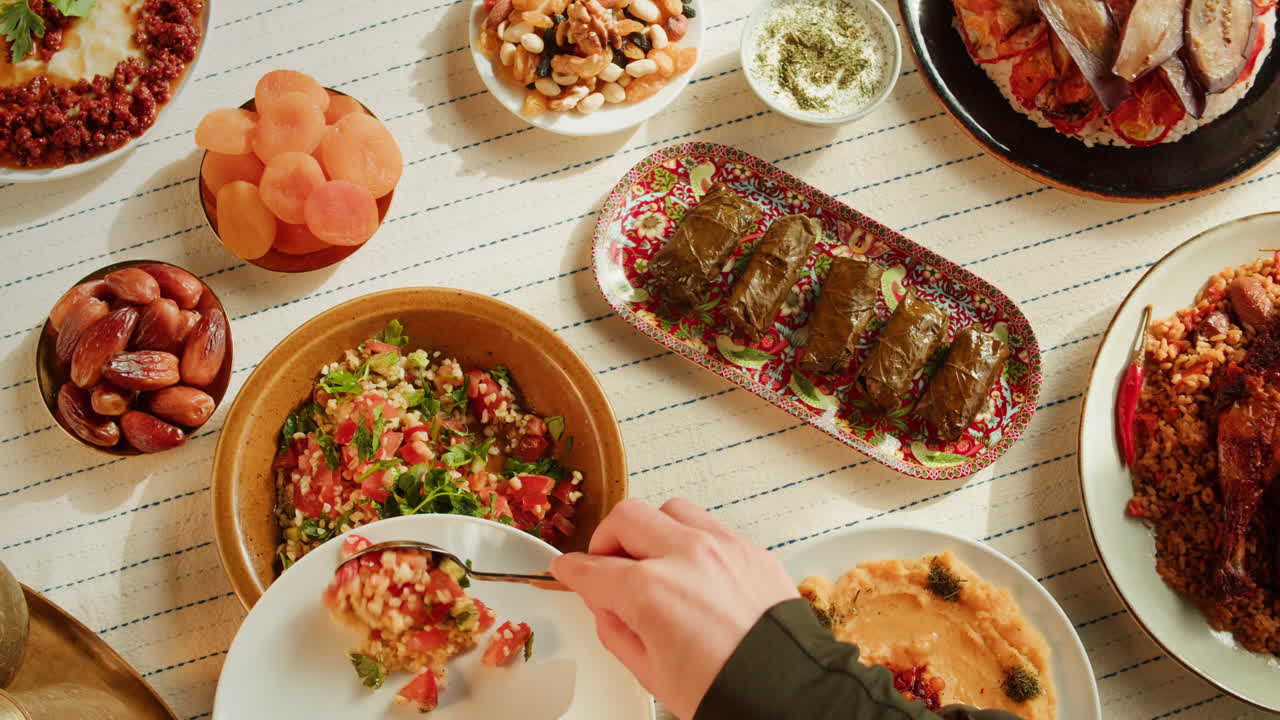 A meal featuring various Middle Eastern dishes, including dolma and salad