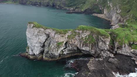 aerial view, kinbane castle ruins on causeway coast and people on steep headland northern ireland, uk